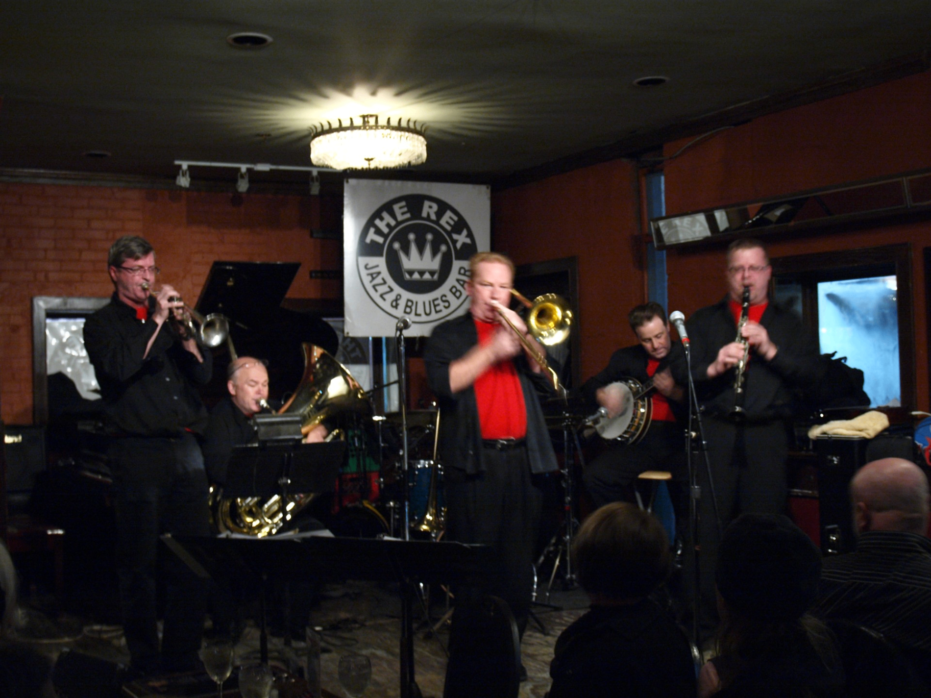 Jazz musician under a golden spotlight in a dim lounge